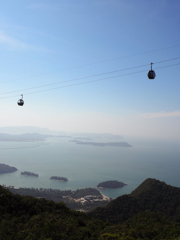 Stunning aerial view of Langkawi's islands and gondola ride, featuring clear blue skies.