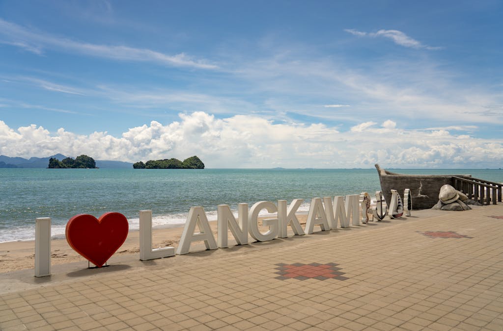 Sunny day at Langkawi beach, featuring iconic I Love Langkawi sign and stunning seascape.